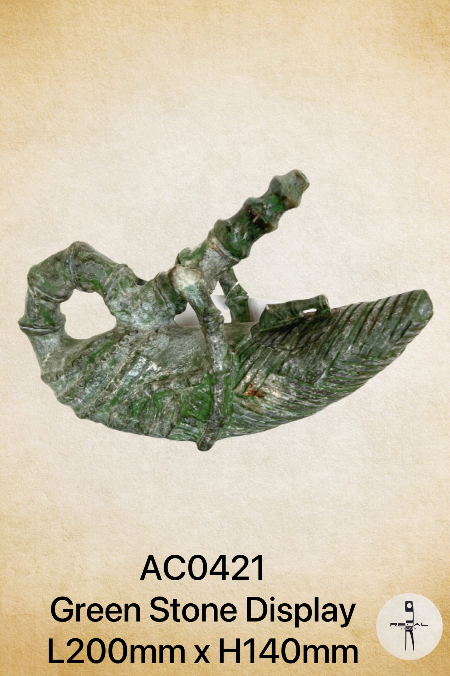 A bronze colored stone figurine of an abstract figure on a boat