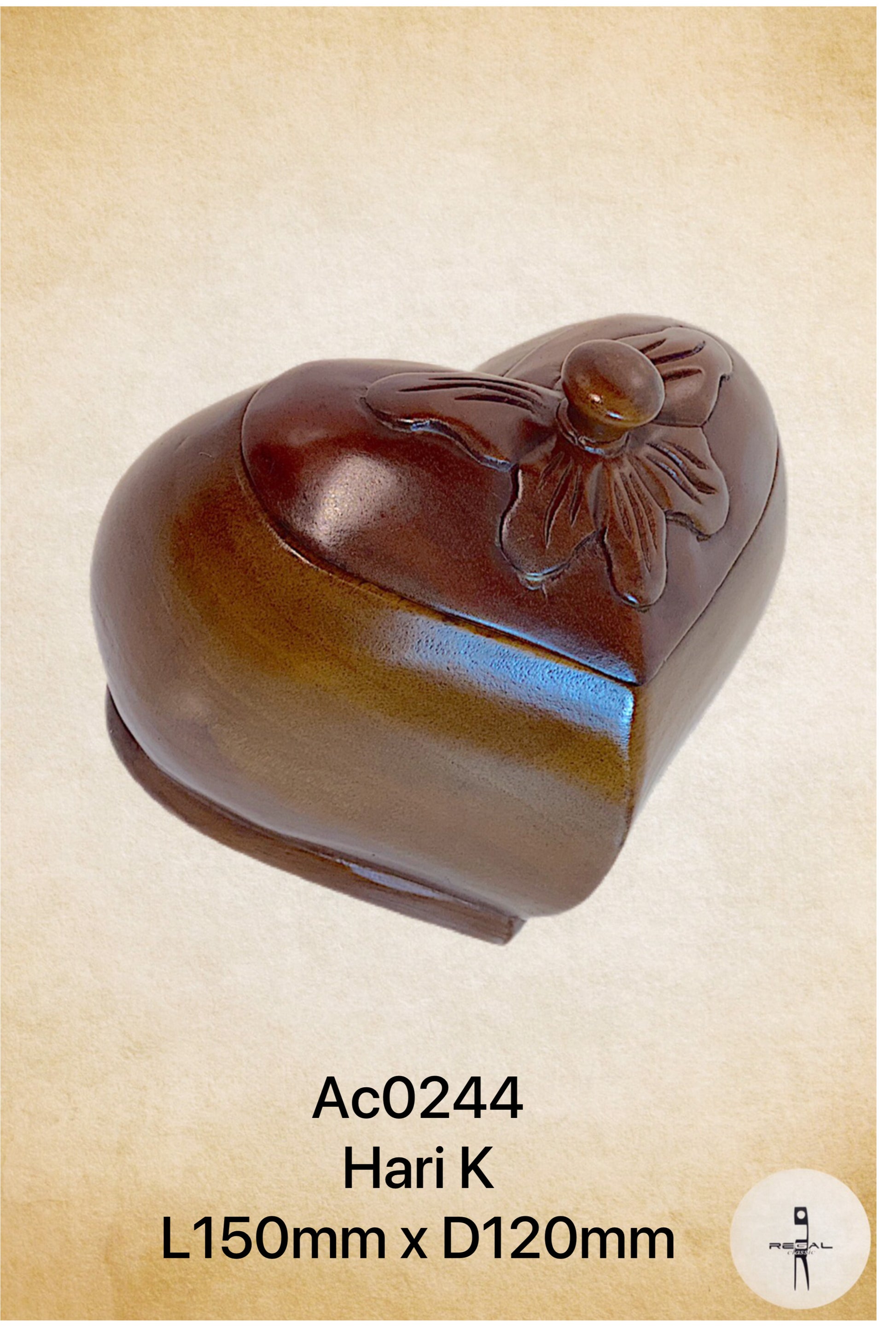 A brown, heart-shaped wooden artwork with a floral pattern on the top.