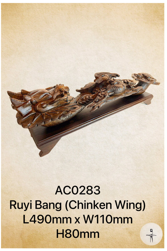 An artwork depicting a dragon in brown color, placed on a wooden stand.