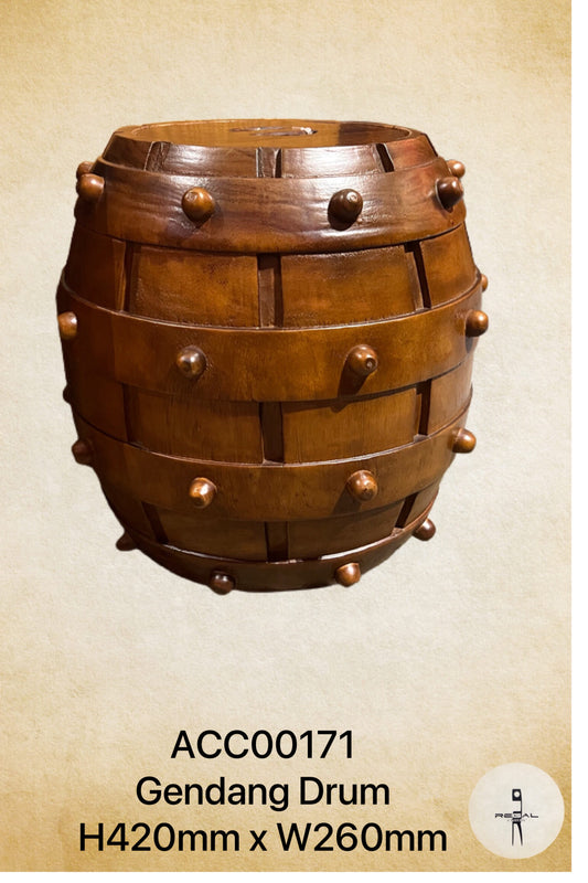A traditional wooden Gendang drum, used as a handcrafted storage box, with visible grain and texture.