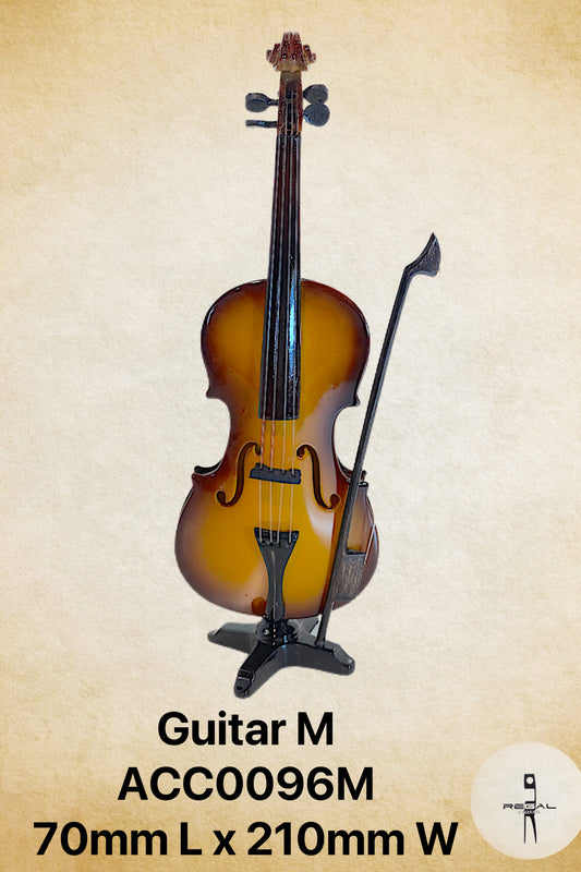 A miniature or toy guitar with a wooden body and a black stand,